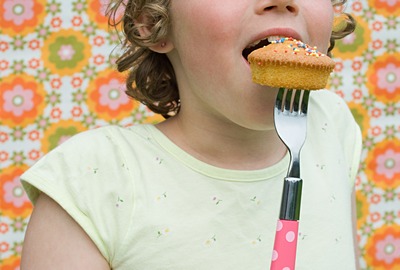 Girl eating cupcake with fork