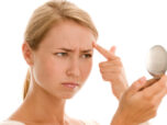 Woman-looking_in_the_mirror
