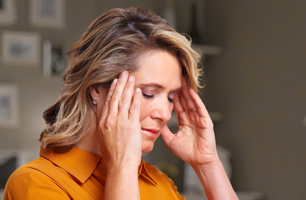 Woman having headache migraine.
