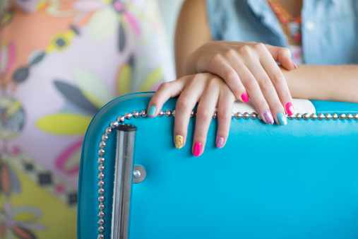 Close up of multicolor fingernail polish on woman's hands - фото