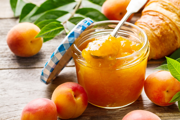 tasty fruit orange apricot jam glass jar with fruits wooden table closeup 1220 1825