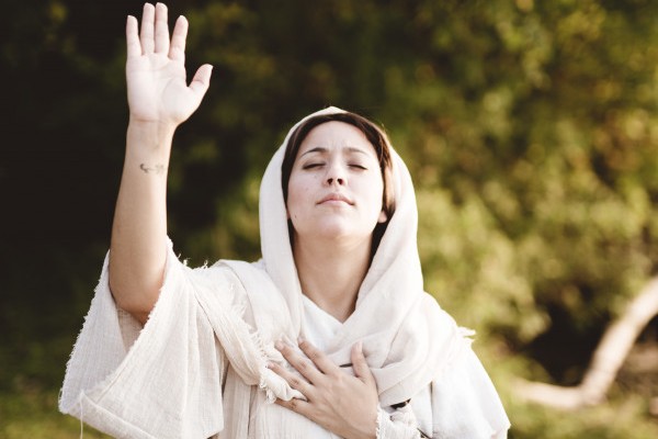 vertical shot female wearing biblical robe with her hands up towards sky praying 181624 6982