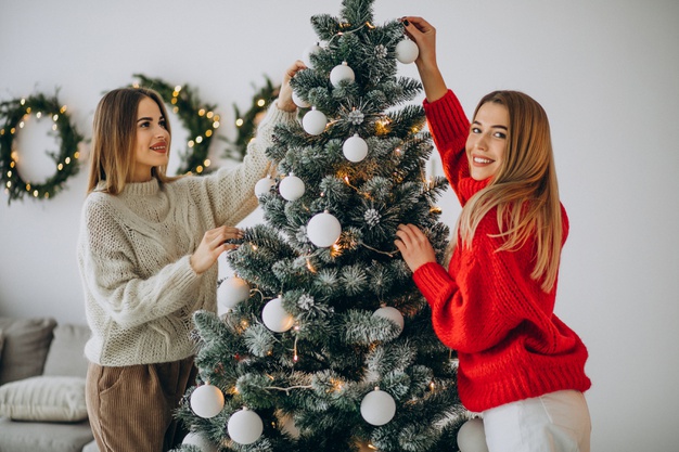 two girls decorating christmas tree 1303 25624